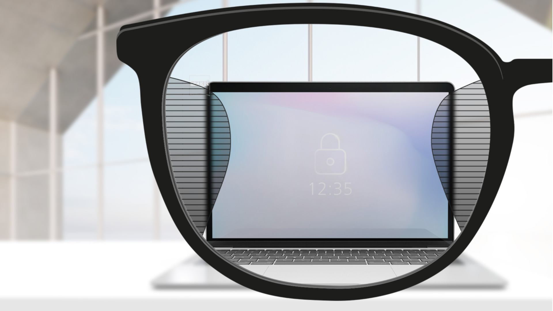 Et synsvinkelbilde med ZEISS Office-glass med en dataskjerm i midten av glasset og slanke uskarpe plott til venstre og høyre.